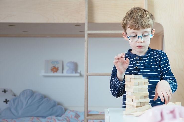 Young child participating in a structured play task as part of an autism evaluation