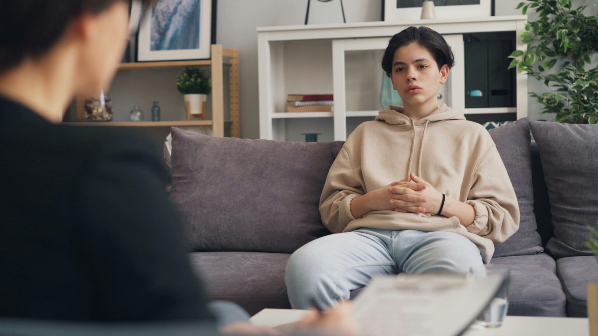 A young person in conversation with a mental health professional during an ADHD assessment session.